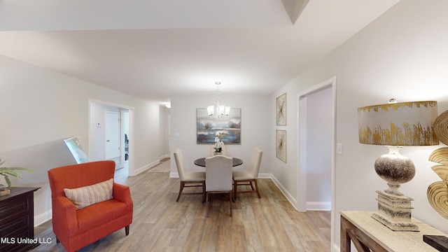 dining area featuring a chandelier and light hardwood / wood-style floors