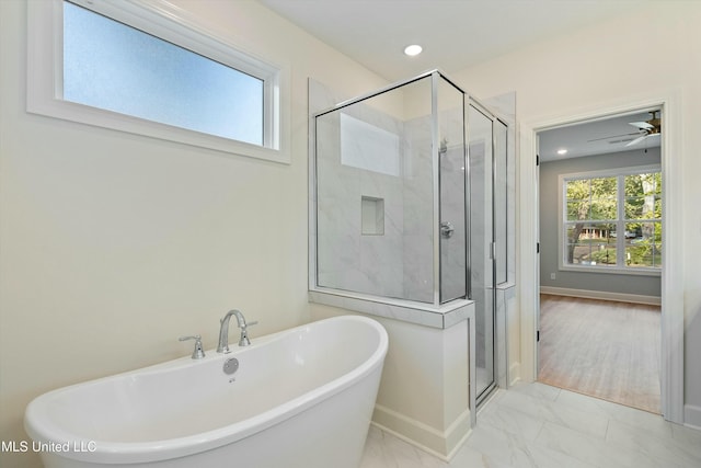 bathroom featuring shower with separate bathtub, ceiling fan, and wood-type flooring