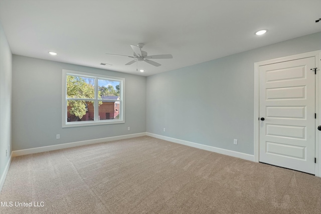 carpeted spare room with ceiling fan