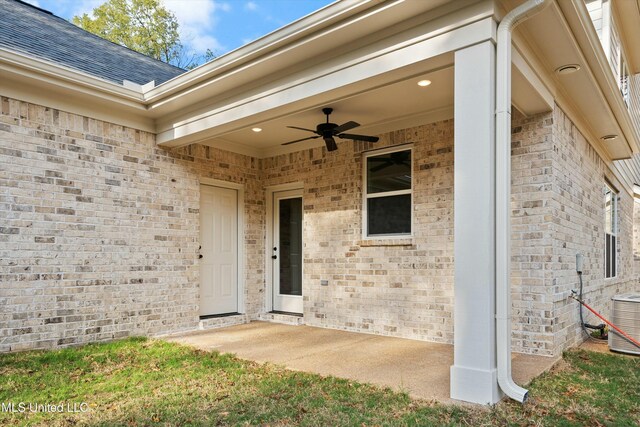 property entrance featuring ceiling fan, cooling unit, and a patio