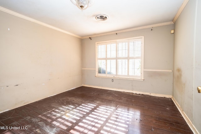 unfurnished room with visible vents, ornamental molding, and hardwood / wood-style flooring