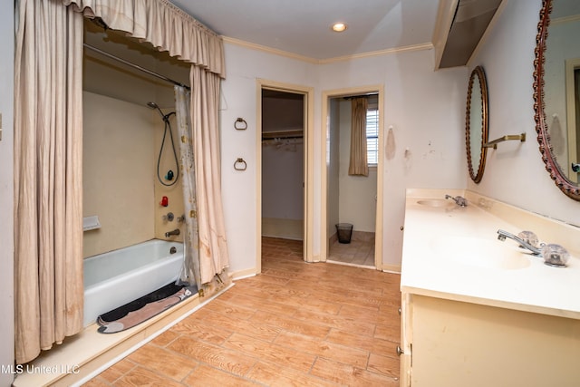 full bath with wood finished floors, a sink, shower / tub combo with curtain, double vanity, and crown molding