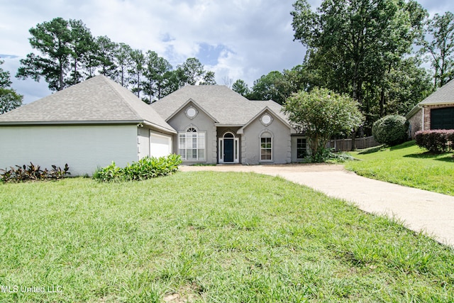 view of front of property with a garage and a front lawn