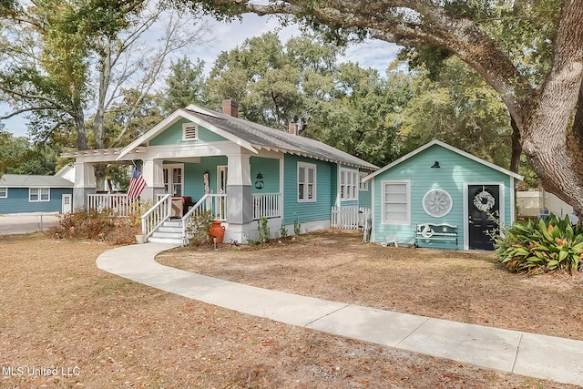 bungalow-style house with a porch and a front yard