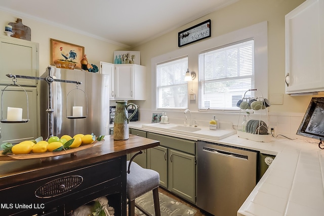 kitchen with sink, crown molding, dishwasher, green cabinetry, and white cabinets