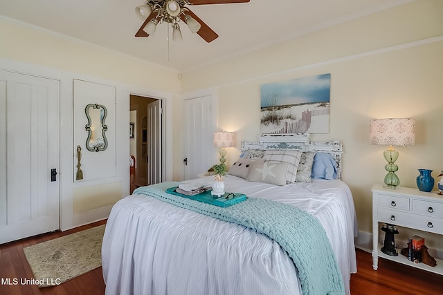 bedroom with dark hardwood / wood-style flooring, ornamental molding, and ceiling fan