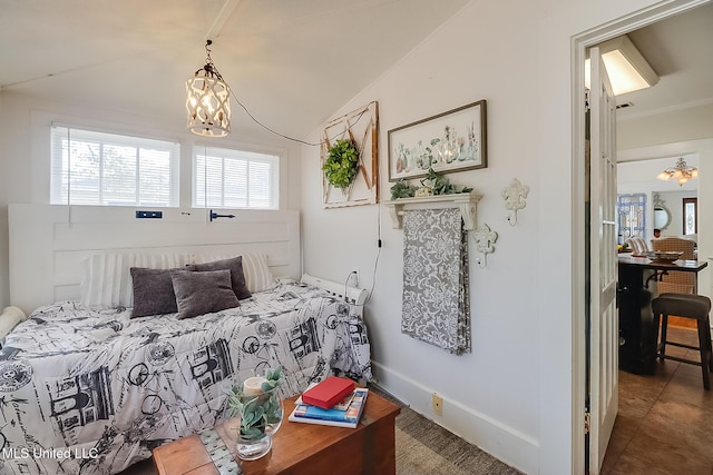 bedroom featuring lofted ceiling and a chandelier