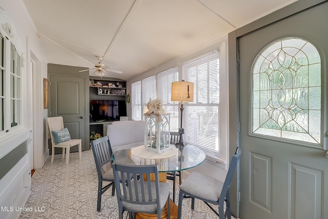 dining space featuring ceiling fan, lofted ceiling, and a healthy amount of sunlight