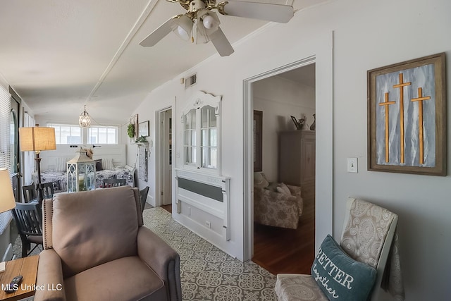 sitting room with crown molding and ceiling fan