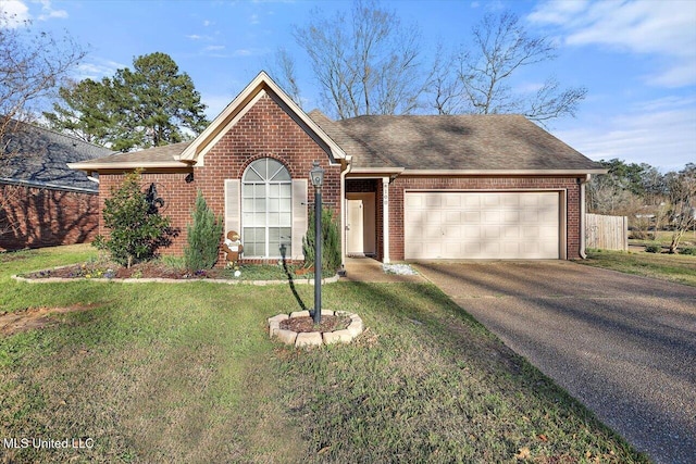 ranch-style home with driveway, an attached garage, a front lawn, and brick siding