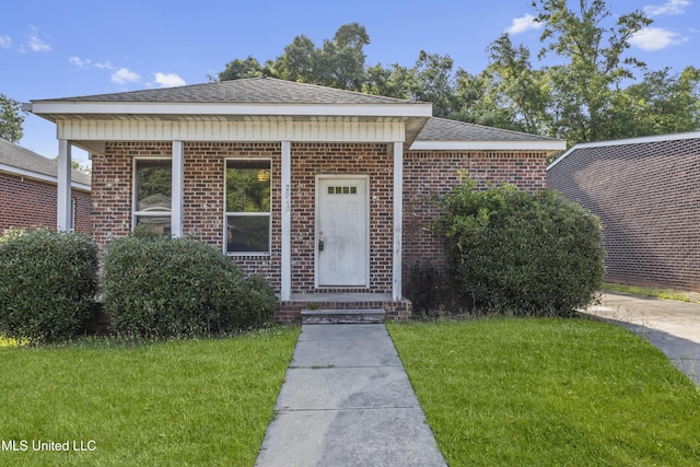 2948 Magnolia Ct, Gulfport, MS 39507 - view of front of house with a front lawn, brick siding, and a shingled roof
