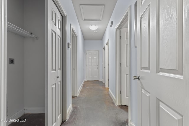 2948 Magnolia Ct, Gulfport, MS 39507 - corridor featuring baseboards, finished concrete floors, and attic access