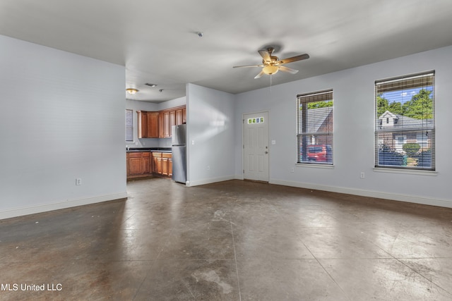 2948 Magnolia Ct, Gulfport, MS 39507 - unfurnished living room with baseboards, a ceiling fan, and concrete floors