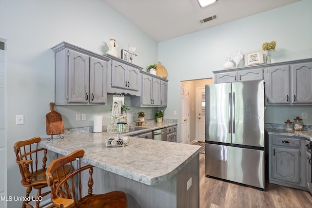 9884 Victor Dr, Olive Branch, MS 38654 - kitchen featuring appliances with stainless steel finishes, a peninsula, and gray cabinetry