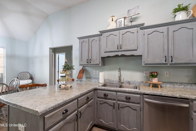 9884 Victor Dr, Olive Branch, MS 38654 - kitchen with dishwasher, a sink, vaulted ceiling, a peninsula, and light countertops