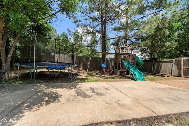 9884 Victor Dr, Olive Branch, MS 38654 - fenced backyard featuring a trampoline and a playground