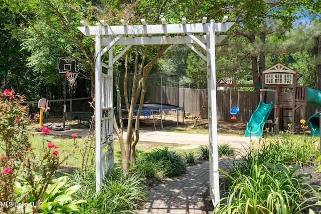 9884 Victor Dr, Olive Branch, MS 38654 - view of yard featuring a trampoline and a playground
