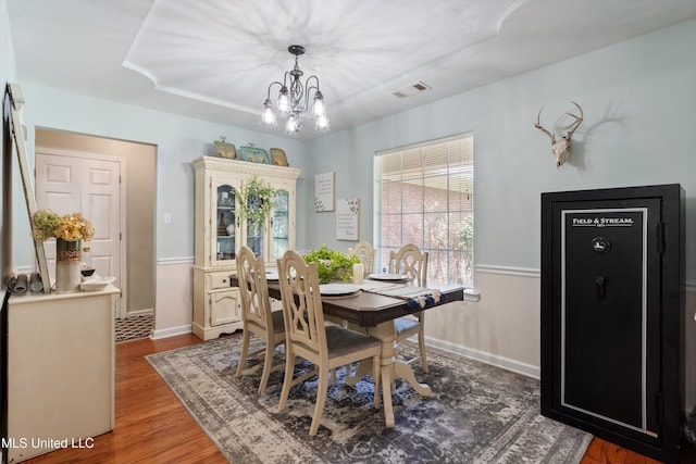 9884 Victor Dr, Olive Branch, MS 38654 - dining space featuring a chandelier, wood finished floors, and baseboards
