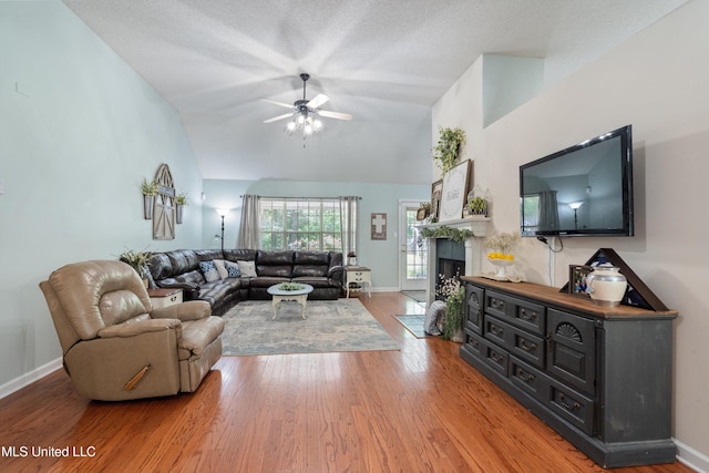 9884 Victor Dr, Olive Branch, MS 38654 - living room featuring ceiling fan, light wood-type flooring, baseboards, high vaulted ceiling, and a fireplace