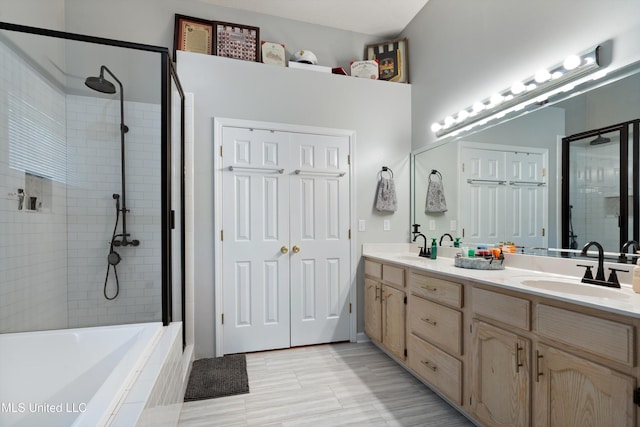 9884 Victor Dr, Olive Branch, MS 38654 - bathroom with tiled shower, double vanity, tiled tub, and tile patterned floors