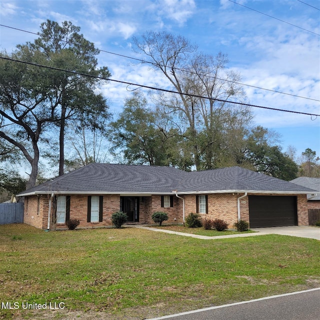 ranch-style home with a garage, a shingled roof, a front lawn, and brick siding