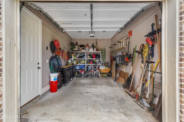 705 Brookwood Cir, Brandon, MS 39042 - garage with a workshop area and a garage door opener