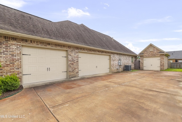 705 Brookwood Cir, Brandon, MS 39042 - view of home's exterior featuring brick siding, central air condition unit, roof with shingles, and a garage
