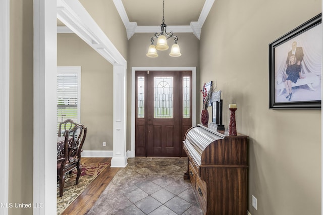 705 Brookwood Cir, Brandon, MS 39042 - foyer featuring ornamental molding, a chandelier, baseboards, and wood finished floors