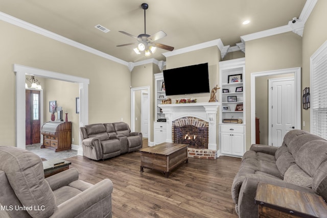 705 Brookwood Cir, Brandon, MS 39042 - living room featuring a brick fireplace, dark wood-type flooring, ceiling fan, ornamental molding, and recessed lighting