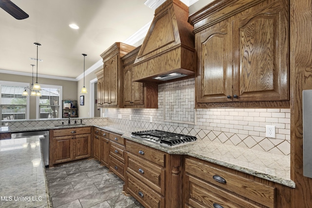 705 Brookwood Cir, Brandon, MS 39042 - kitchen with appliances with stainless steel finishes, a sink, crown molding, decorative backsplash, and hanging light fixtures