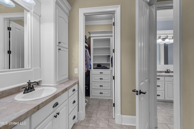 705 Brookwood Cir, Brandon, MS 39042 - bathroom featuring vanity, crown molding, a walk in closet, and tile patterned flooring