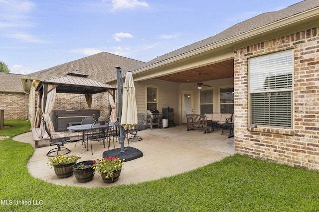 705 Brookwood Cir, Brandon, MS 39042 - view of patio / terrace with ceiling fan, a hot tub, a gazebo, and outdoor dining space