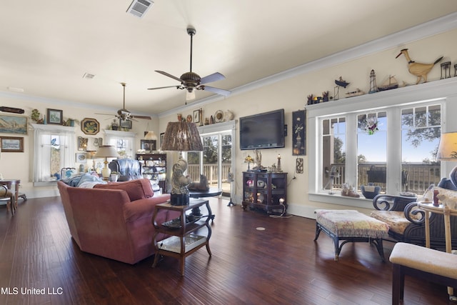 living room with crown molding, a wealth of natural light, and dark wood-type flooring