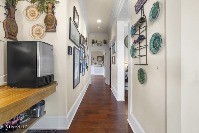 hall featuring dark hardwood / wood-style flooring and crown molding