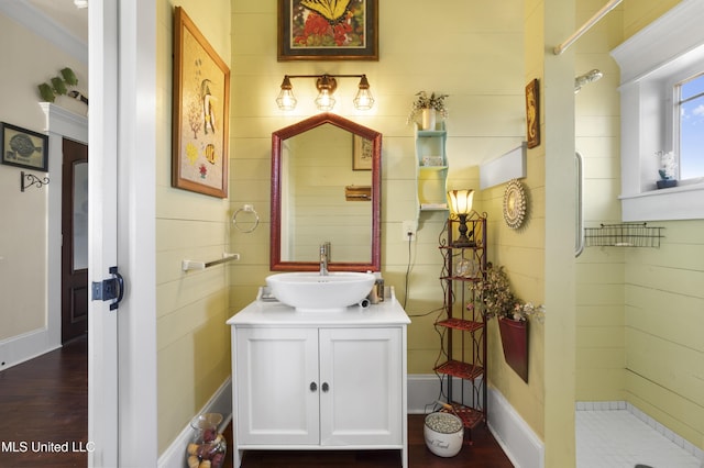 bathroom featuring a shower, hardwood / wood-style floors, vanity, and crown molding