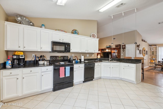 kitchen with black appliances, lofted ceiling, white cabinets, and kitchen peninsula