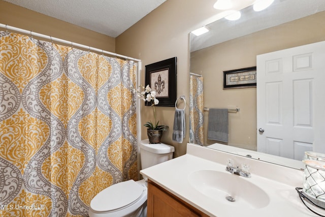 bathroom with vanity, a textured ceiling, and toilet