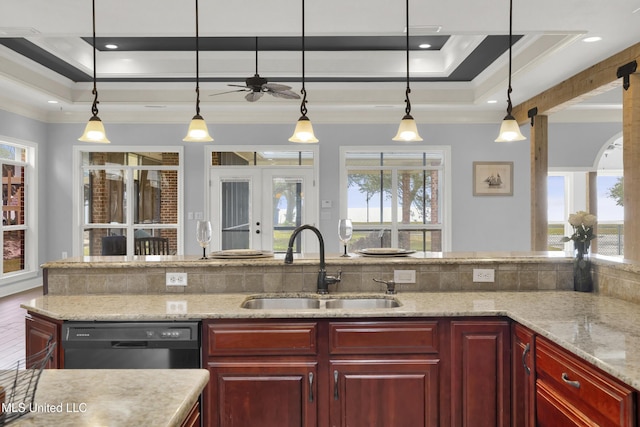 kitchen featuring a sink, a tray ceiling, reddish brown cabinets, crown molding, and dishwasher