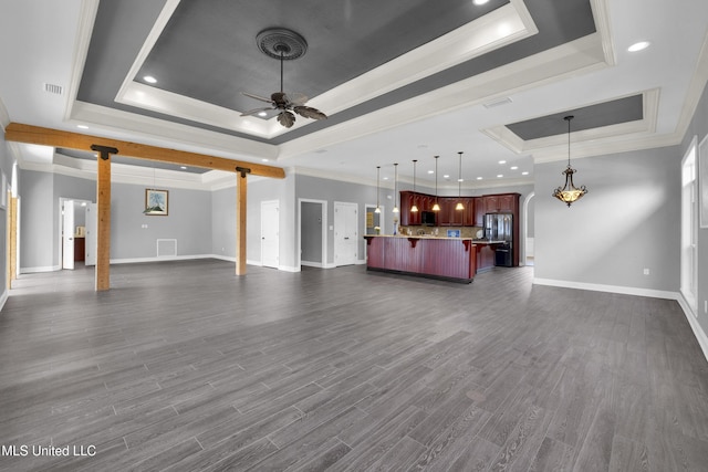 unfurnished living room featuring crown molding, baseboards, dark wood finished floors, a raised ceiling, and a ceiling fan