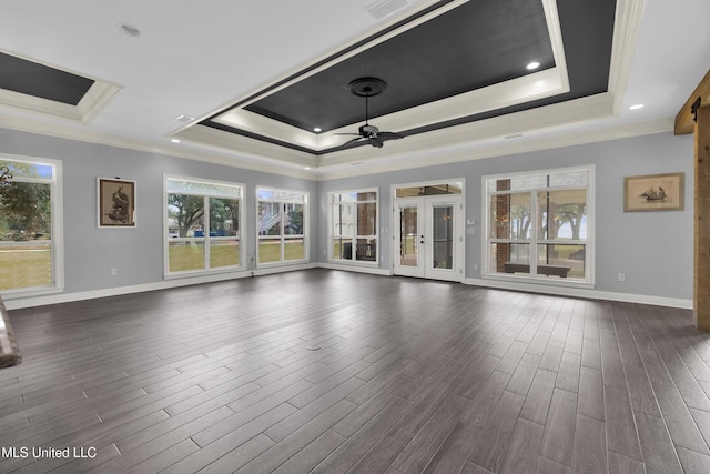 unfurnished living room with french doors, a ceiling fan, dark wood-type flooring, and a tray ceiling