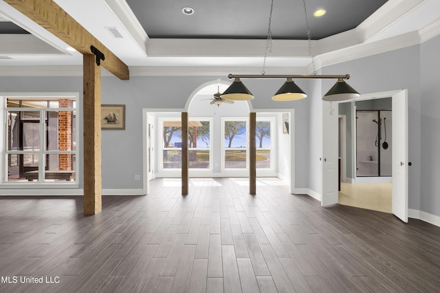 unfurnished dining area with dark wood finished floors, a raised ceiling, and visible vents