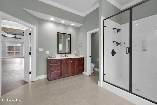 bathroom featuring vanity, toilet, a stall shower, and ornamental molding