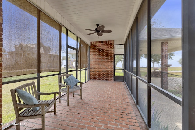 sunroom featuring plenty of natural light and a ceiling fan