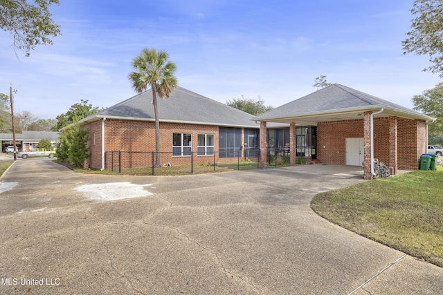 exterior space with an attached carport, driveway, and fence