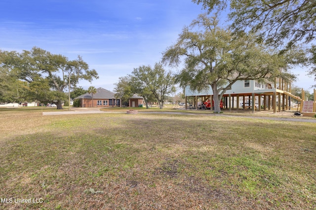 view of front of home featuring a carport, a front yard, and stairs