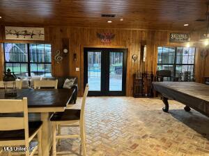 interior space featuring wooden walls, plenty of natural light, wood ceiling, and pool table