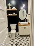 bathroom featuring tile patterned floors, toilet, and sink