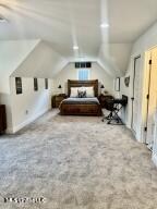 bedroom with lofted ceiling