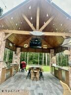 view of patio with a gazebo, ceiling fan, and exterior kitchen