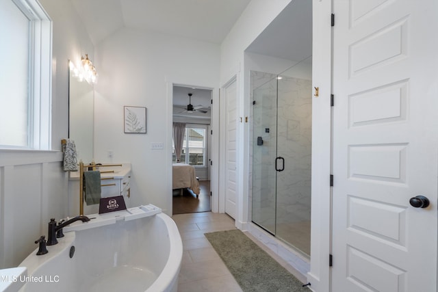 full bathroom with connected bathroom, vaulted ceiling, a stall shower, tile patterned floors, and vanity